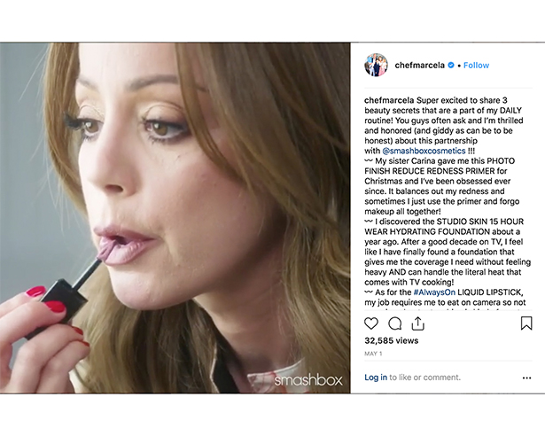 Woman putting on lip gloss