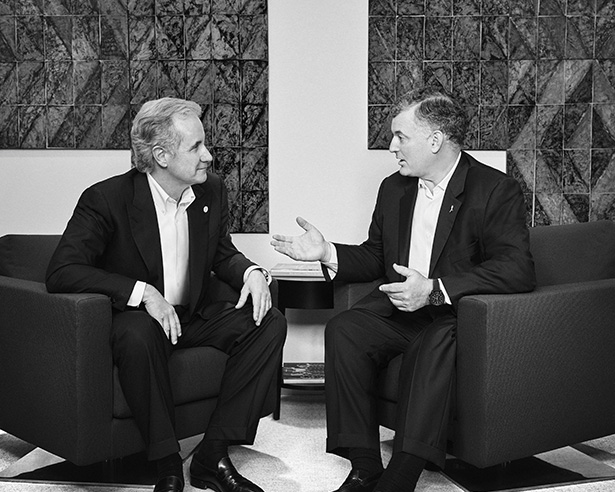 Two men in suits having a conversation