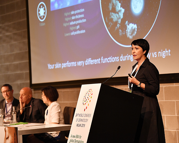 Woman speaking at a podium at a conference
